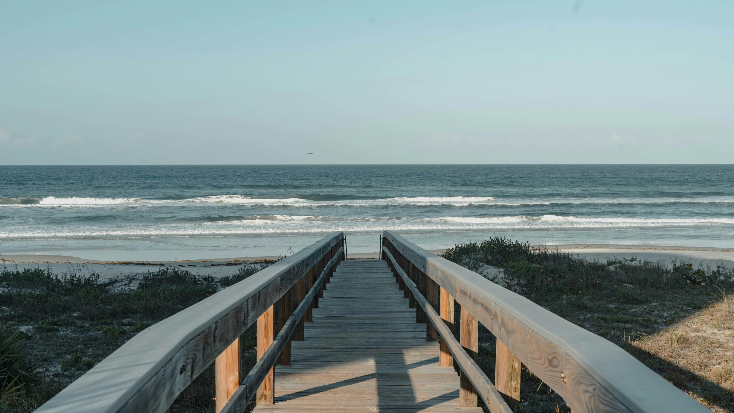 a beach with many small waves coming in and out