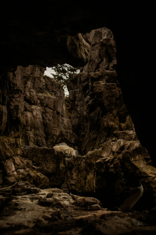 large rocky formations are displayed as if there is a man in the center of the rock