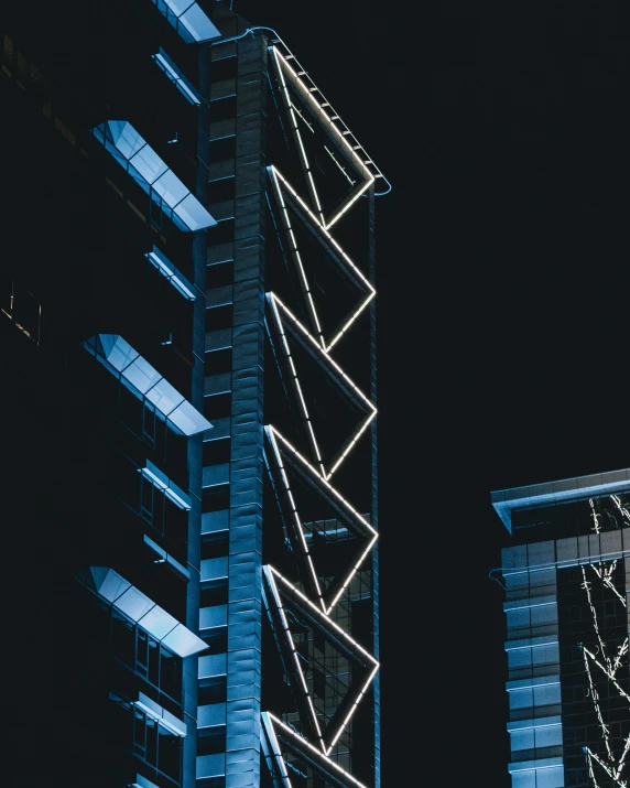 a very tall building with lights around it at night