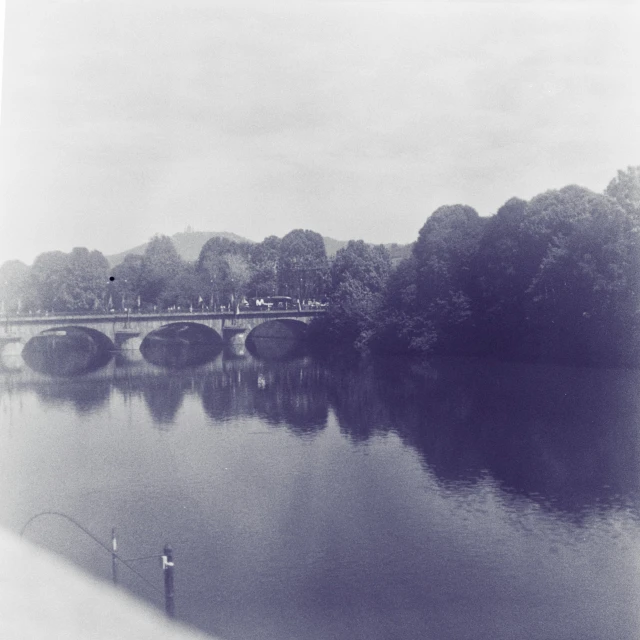 black and white pograph of a bridge over a river