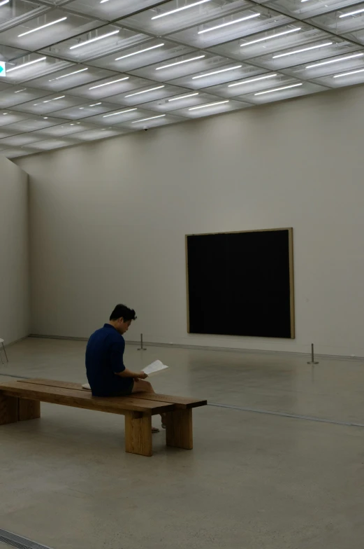 a man sitting on a bench in a building