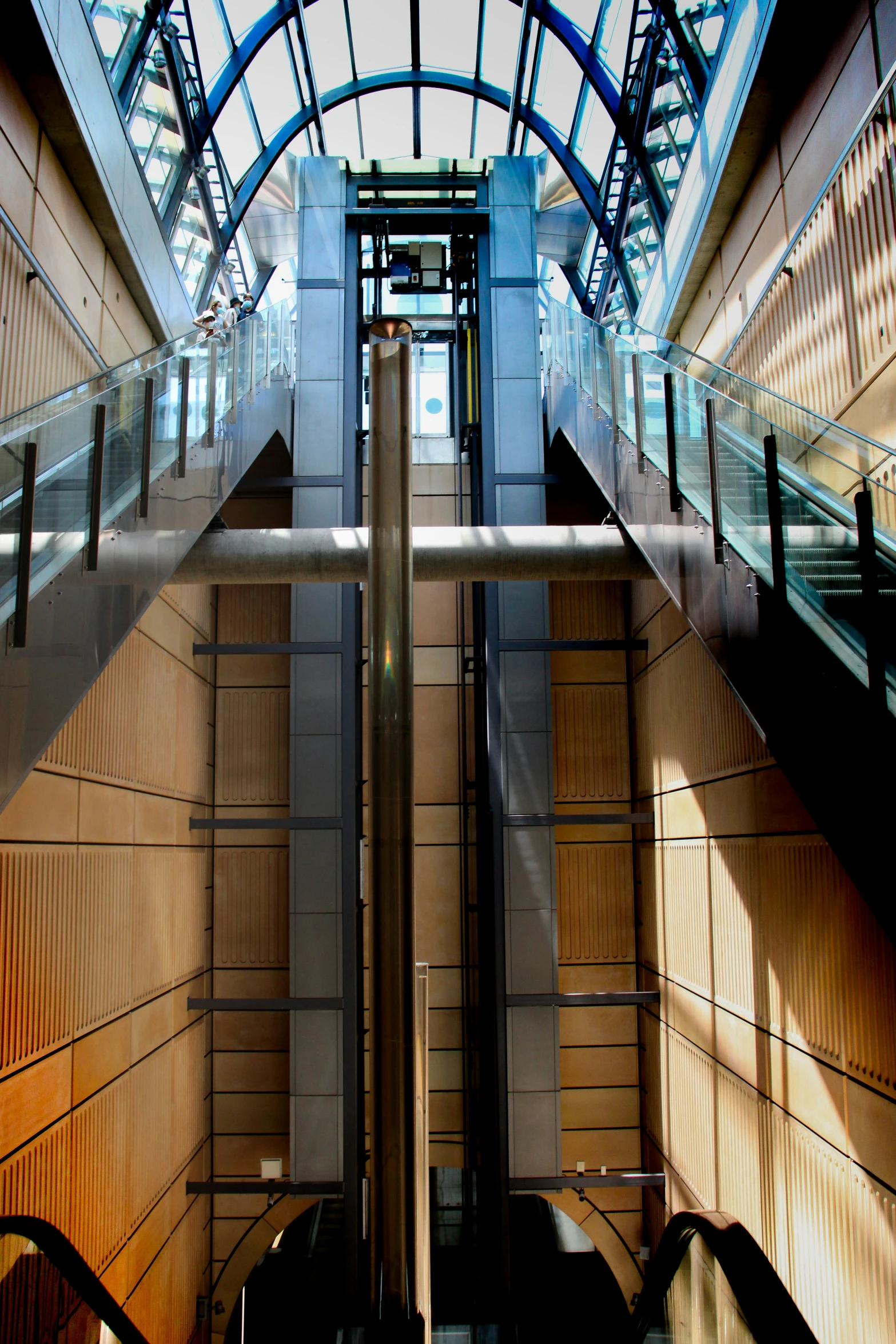 an escalator in an underground terminal with skylights