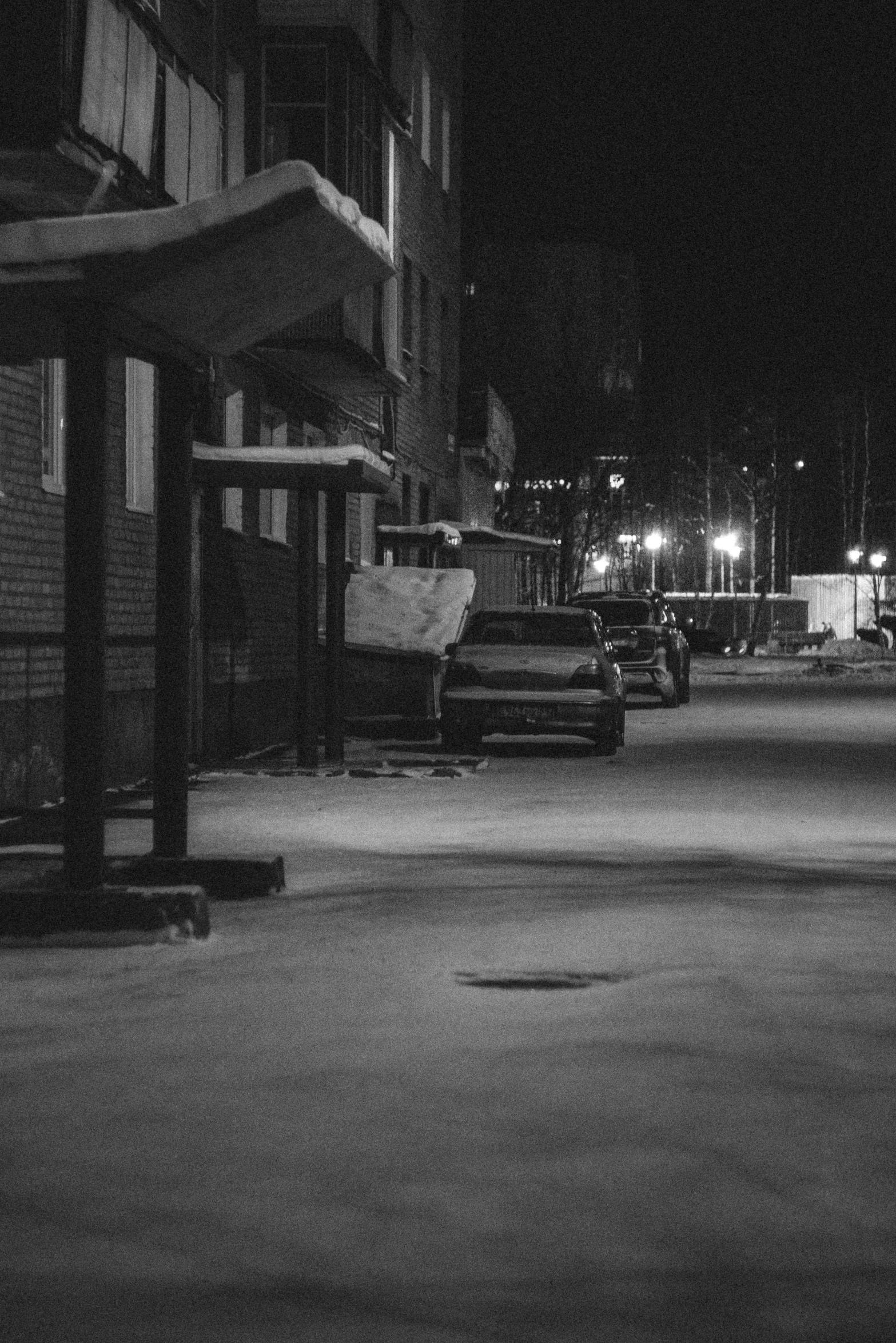 a black and white po of city street at night