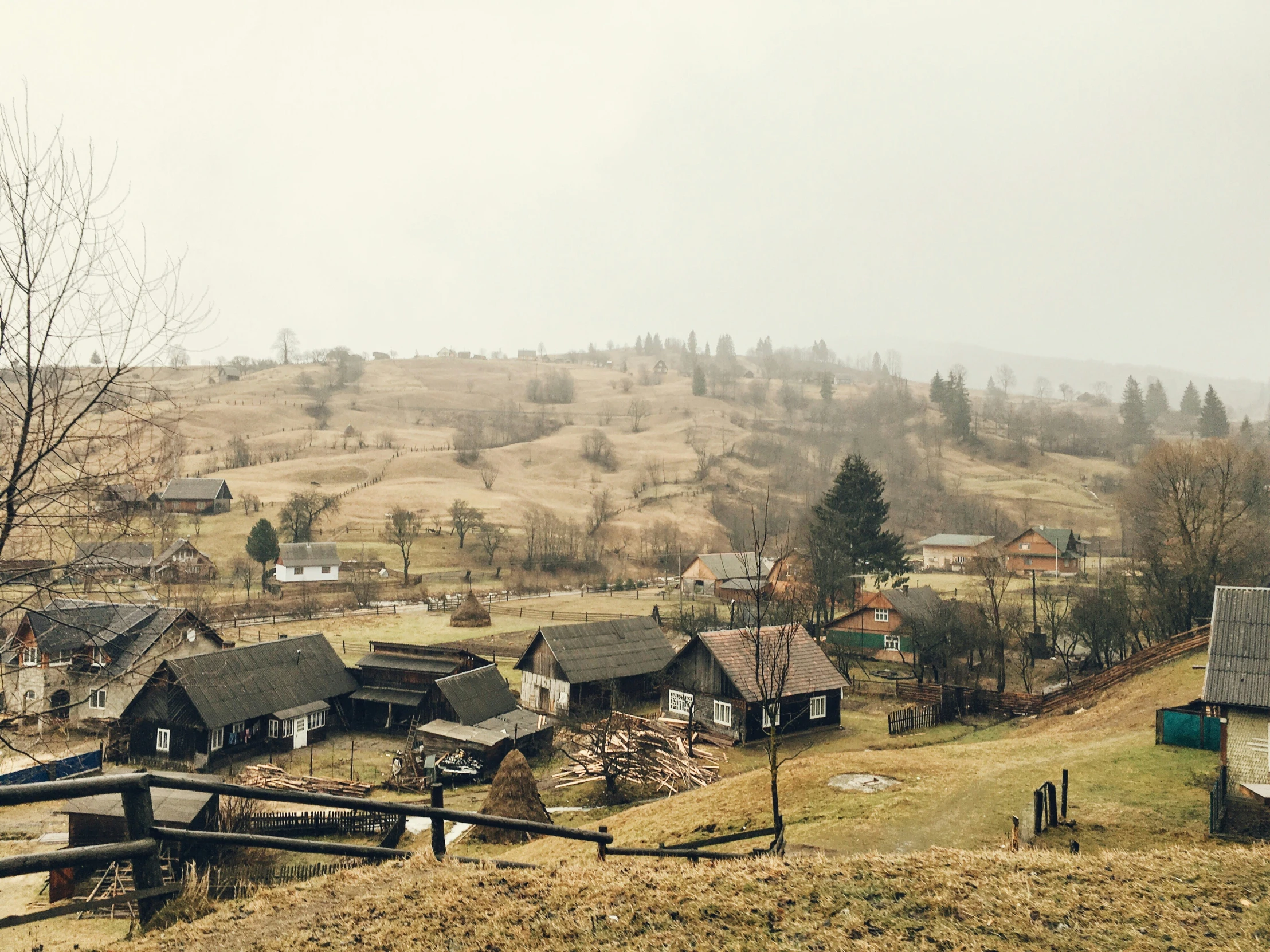 an overview of a small country town with lots of houses and trees