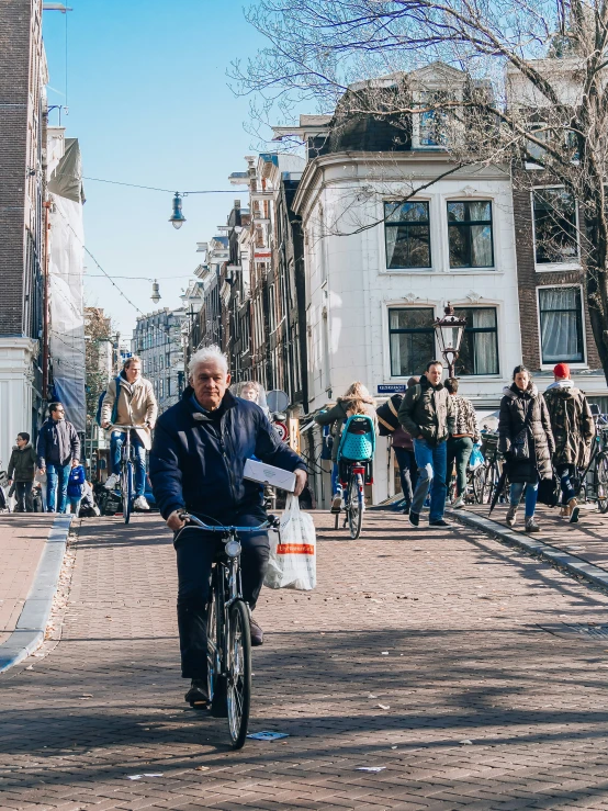 a man riding a bike on a crowded street