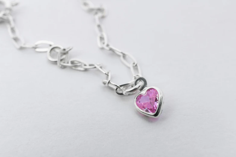 a heart pendant is attached to a silver chain