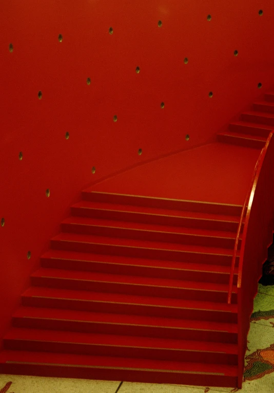 a red wall with a bunch of stairs in it