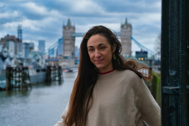 a young woman posing with the skyline in the background