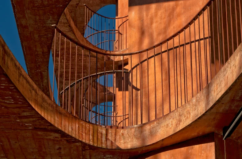 a large spiral staircase next to two old buildings