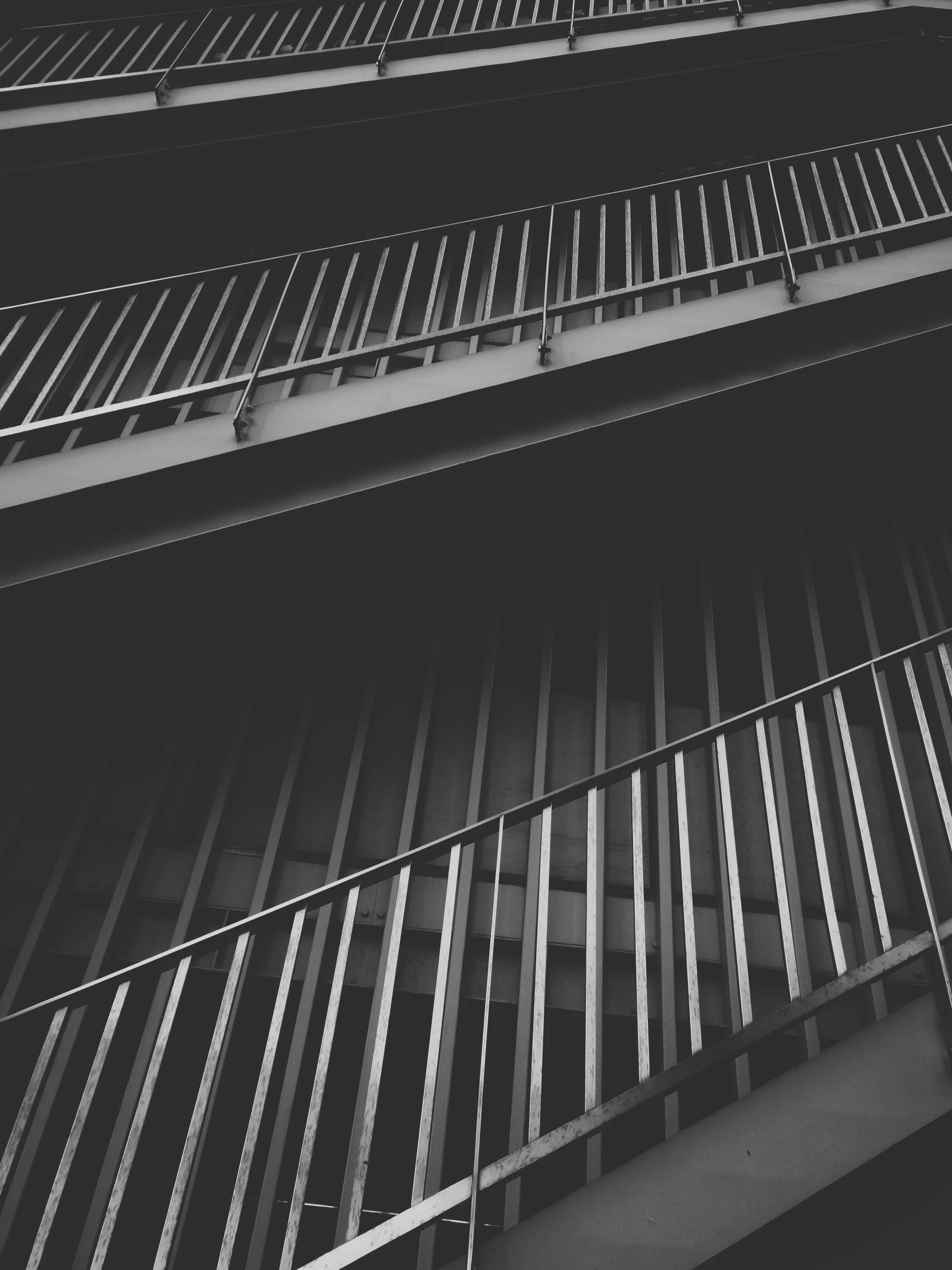 multiple balconies with railings on them near the ground