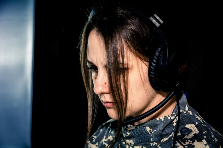 a woman with headphones on and looking down at her wrist