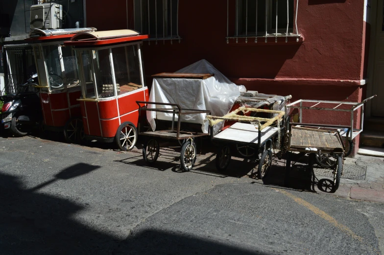 an old fashioned trolley pulled by a moped and cart