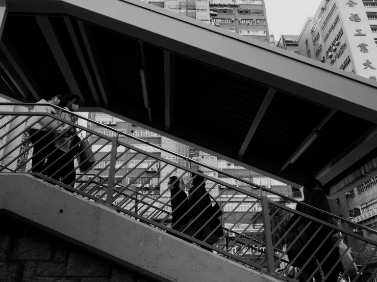 people are walking down the stairs on a city street