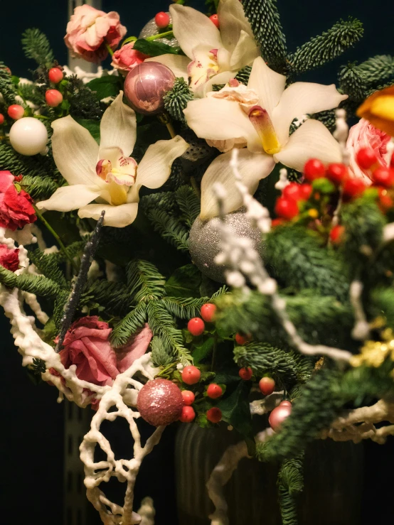 a vase full of christmas decorations on a table