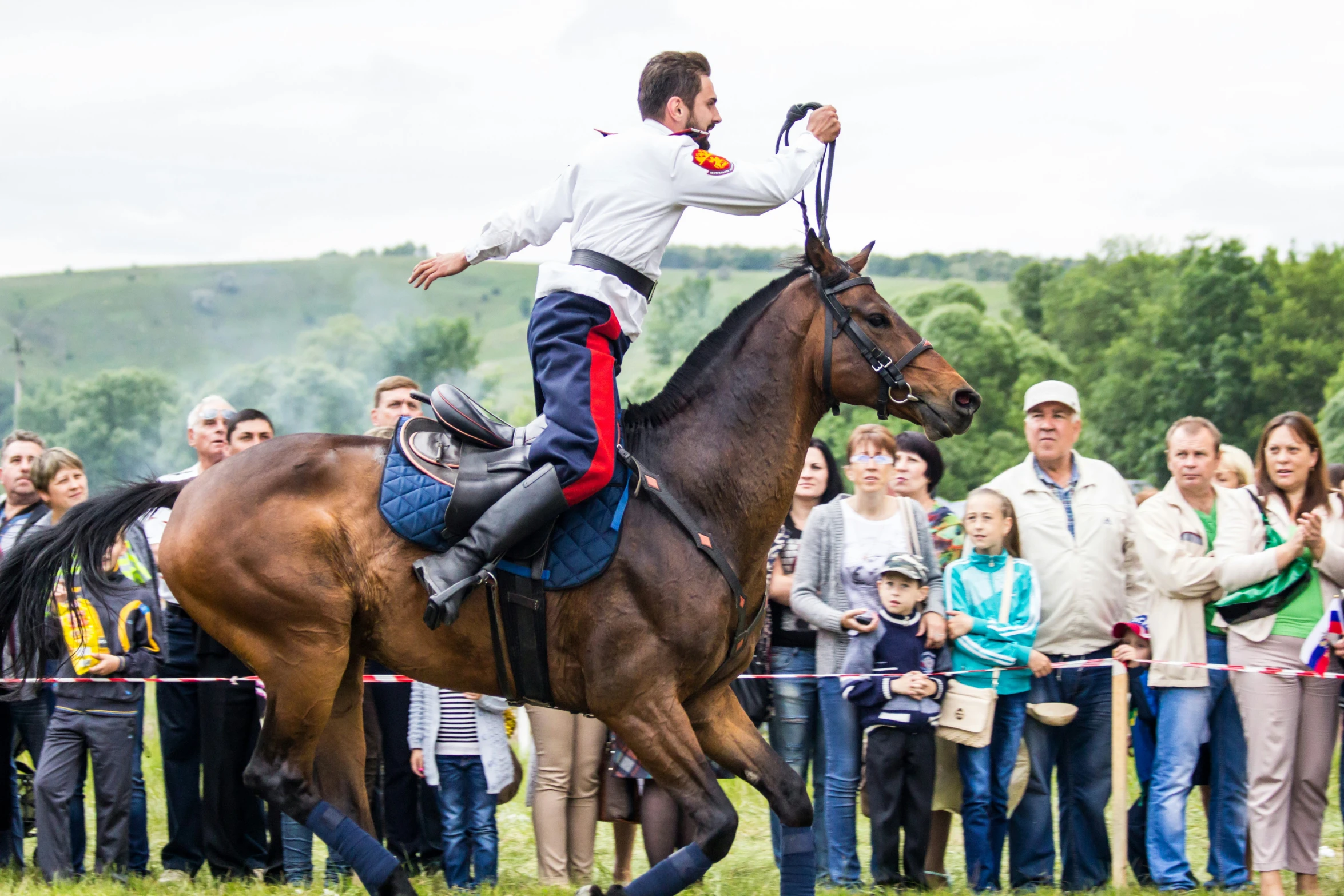 a man riding on the back of a brown horse