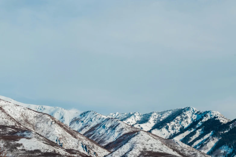 a snowy mountain range against the blue sky