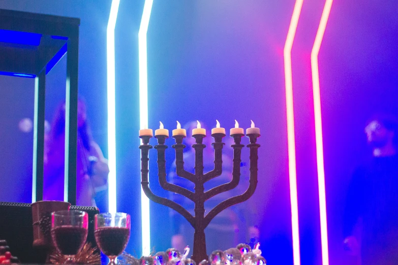 menorah and candles on a table with several other objects