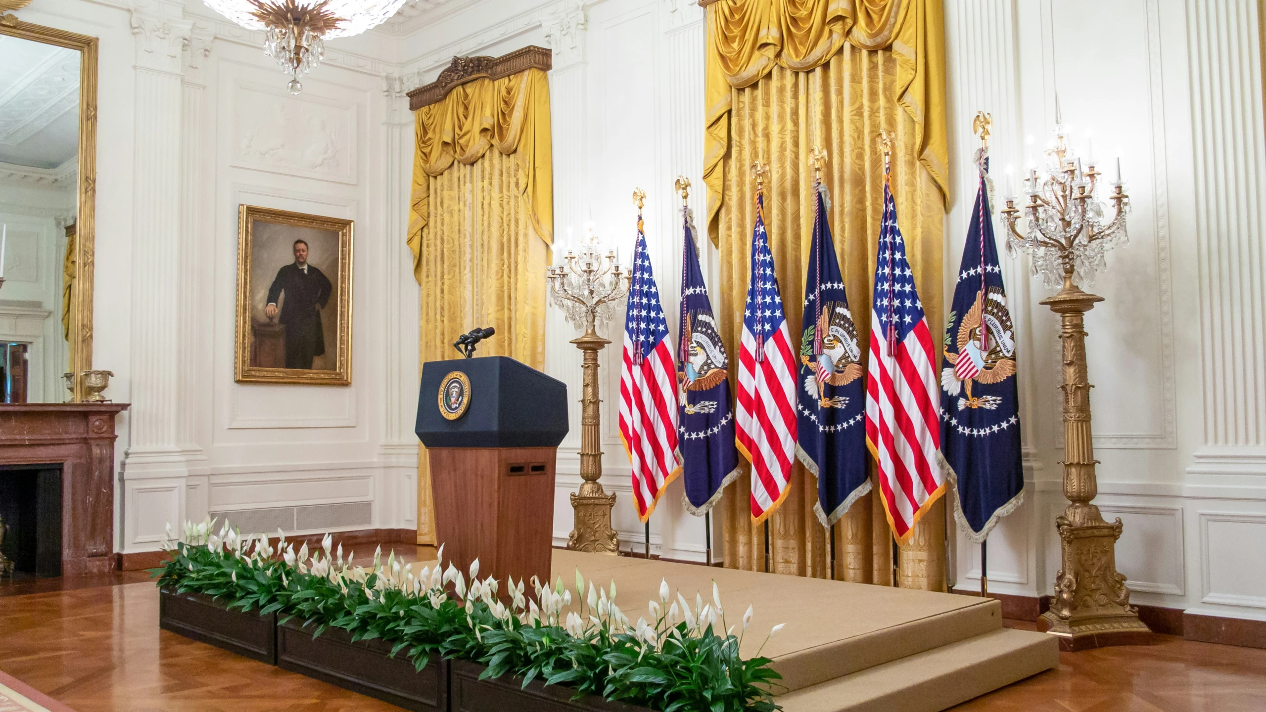 the white house press room with state flag on display