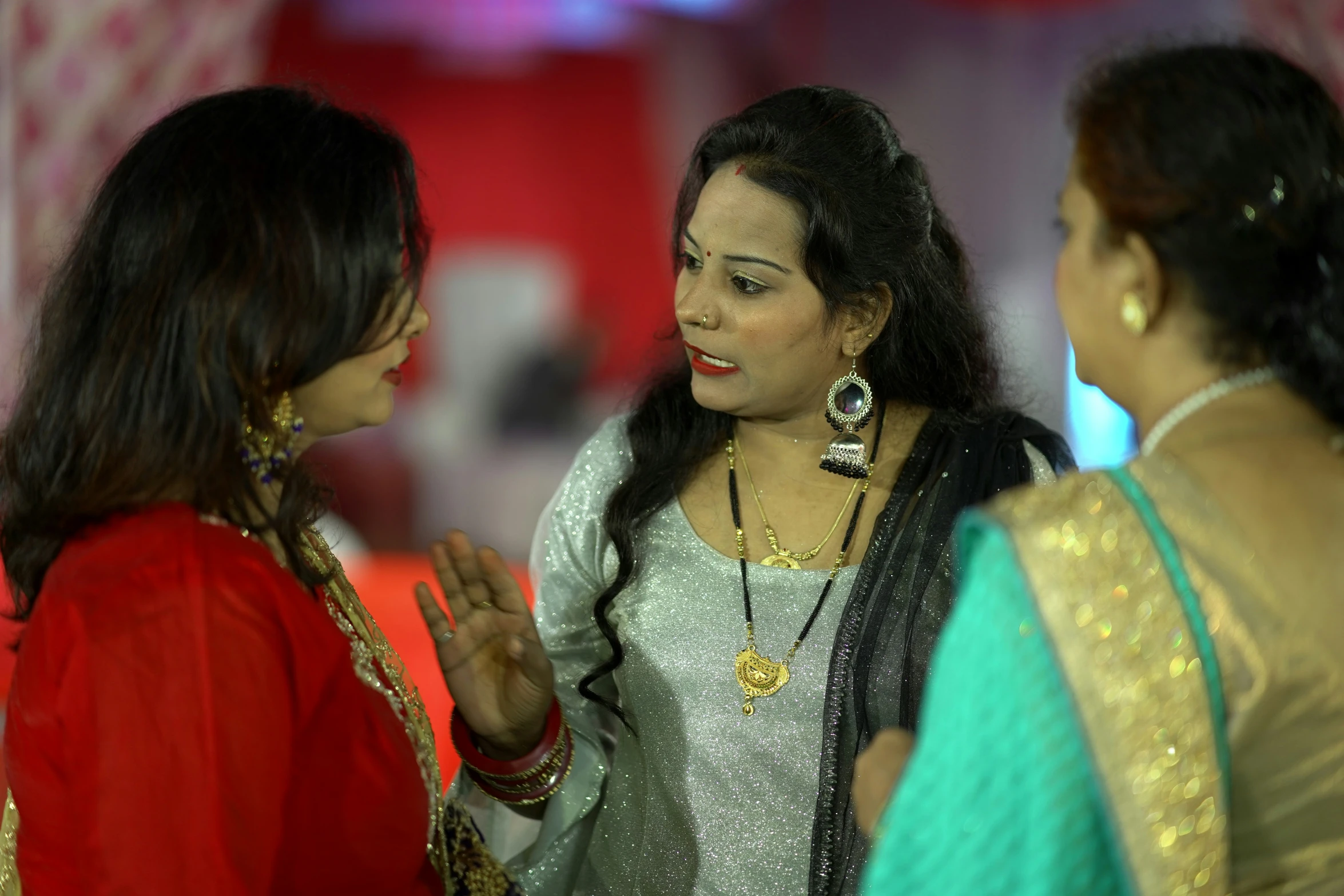 two women standing together and talking with each other