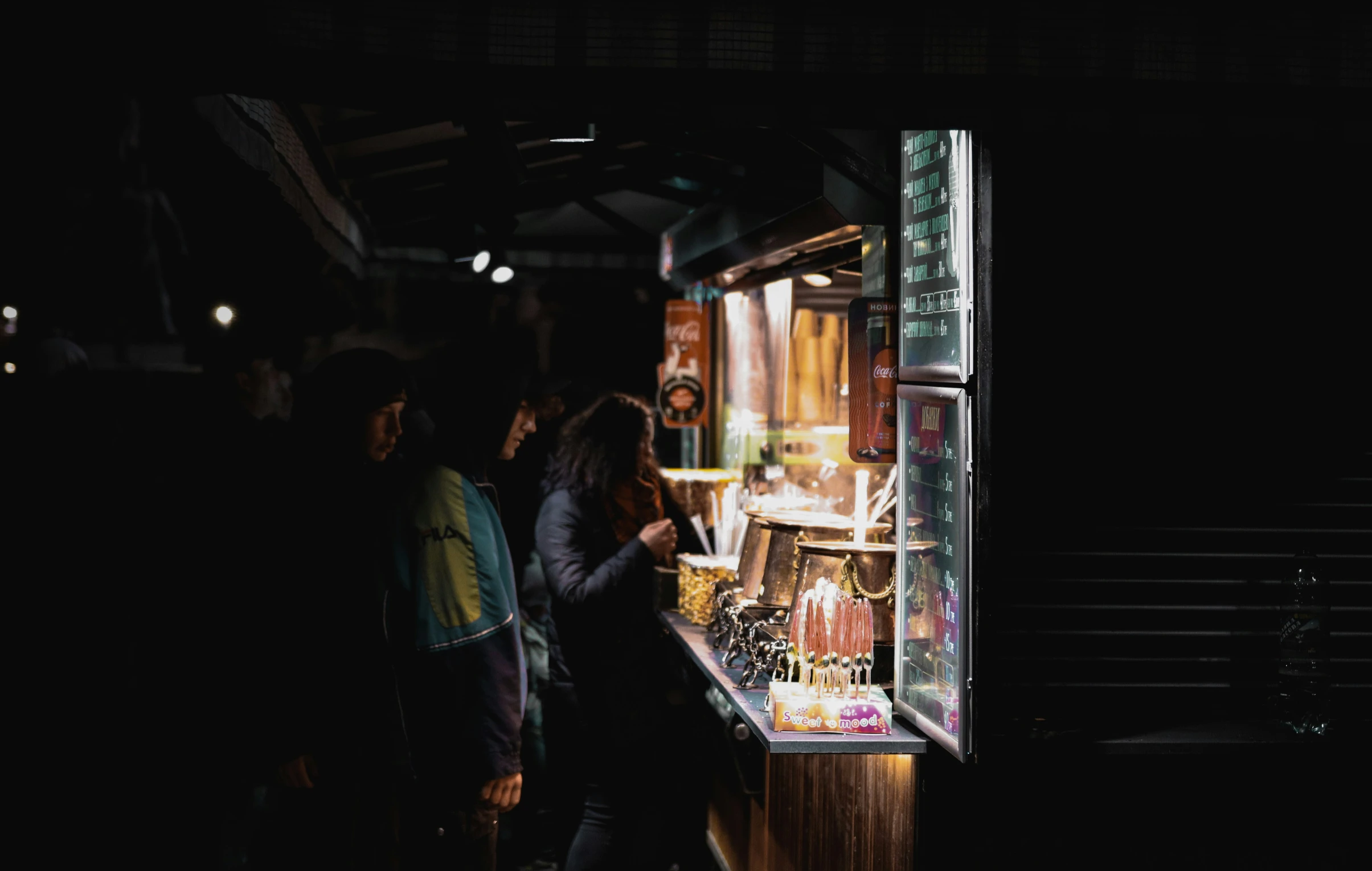 group of people walking in front of display case