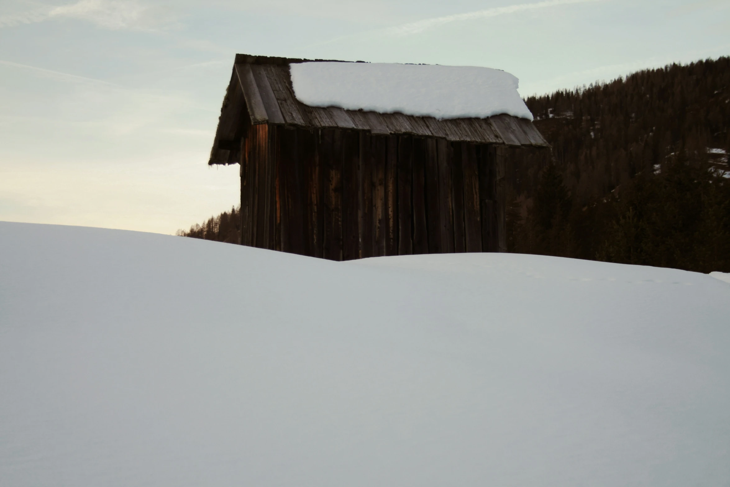 a wooden building in a snowy landscape