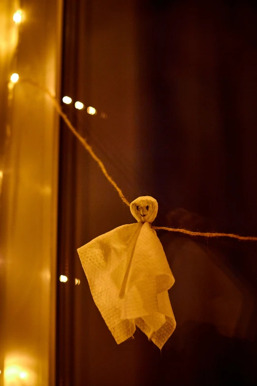 a white towel hanging on a line in front of a mirror