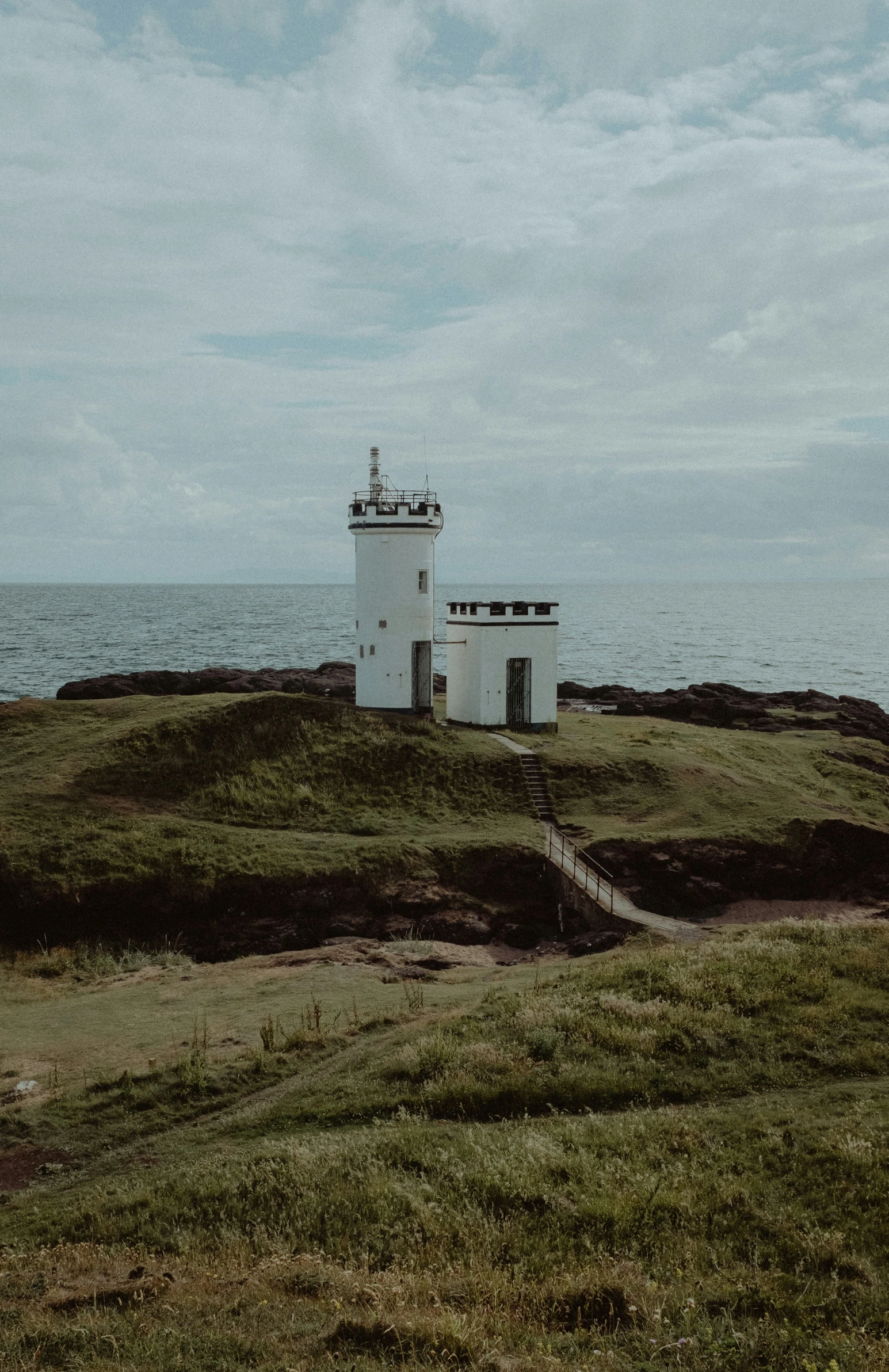 an island on the ocean is on a cloudy day