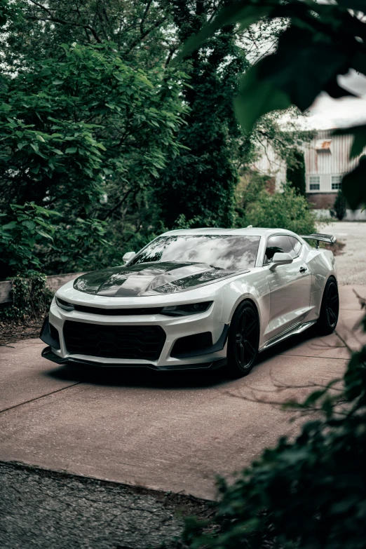 a white car parked on top of a driveway