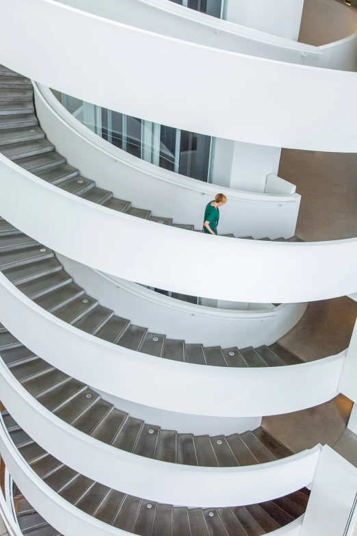 man walking down stairs in a modern building