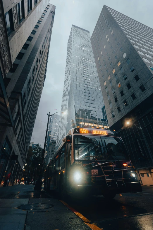 city bus driving through a busy area with skyscrs