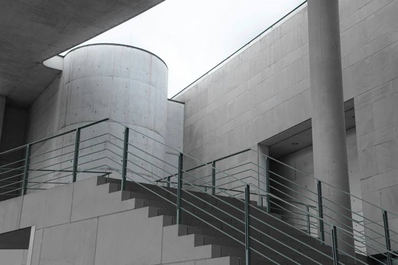 two cement buildings with a stairway near each other