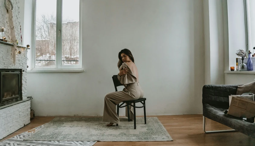 a woman sitting on a chair in a room