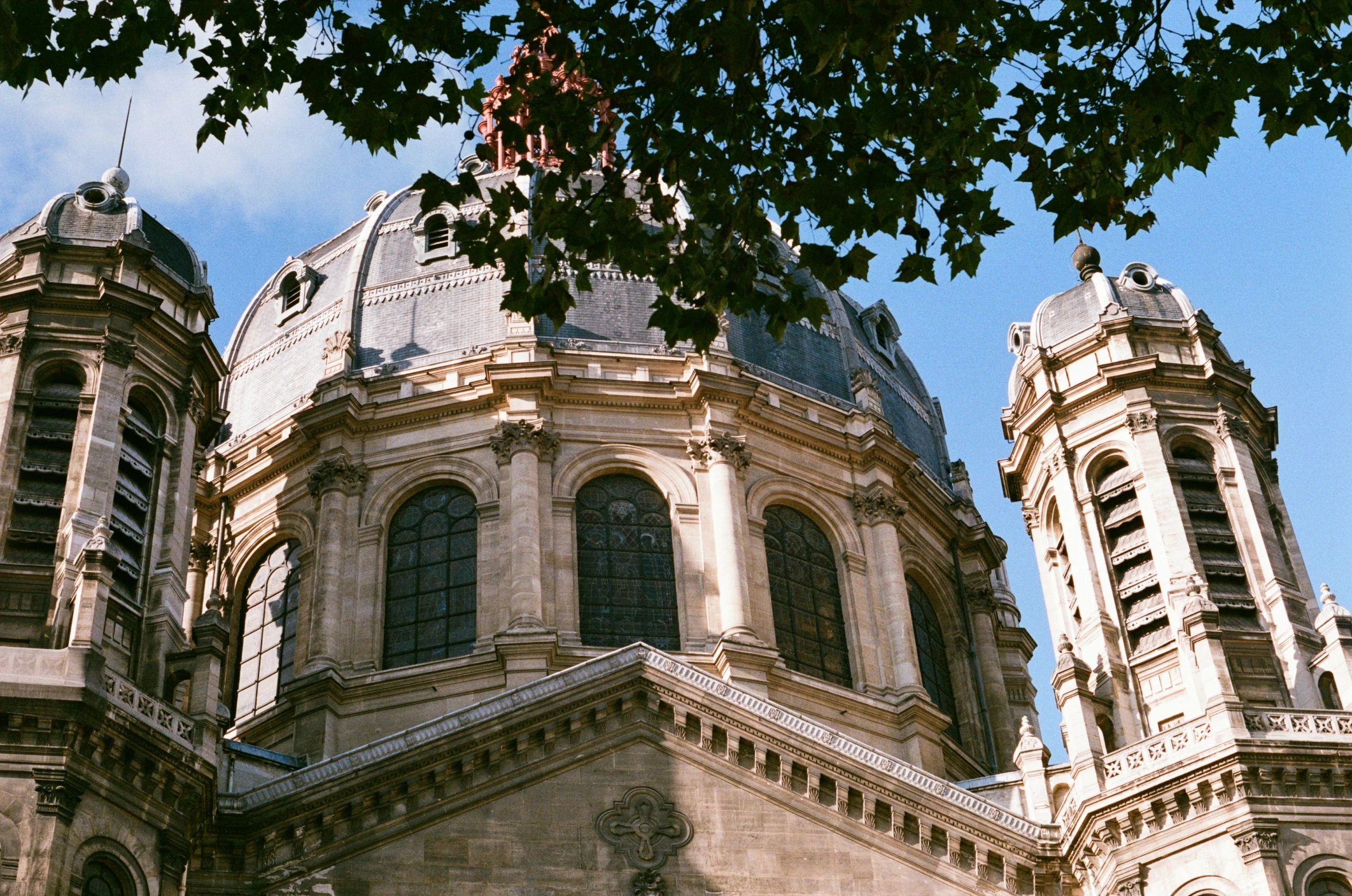 some buildings with a sky background and trees