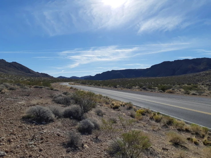 a country road winding into the mountains