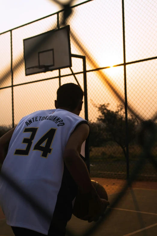 a person standing in front of a basketball hoop