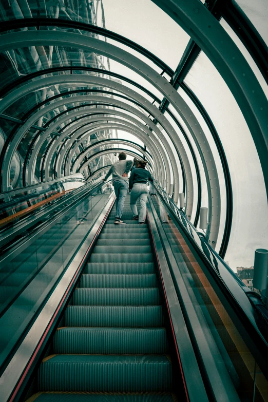 a couple is walking up some escalators