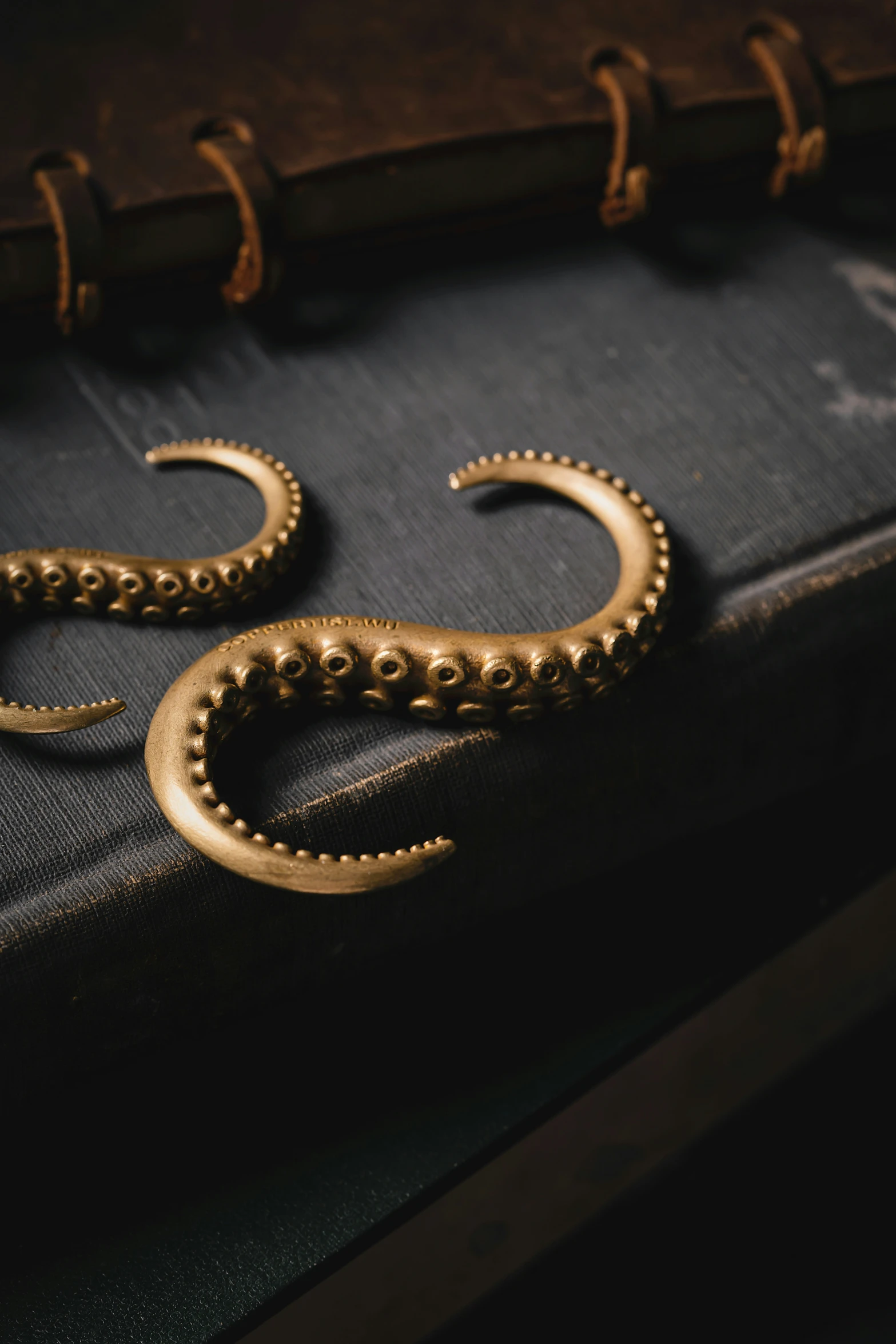 an old, antique book is covered in gold metal ornaments