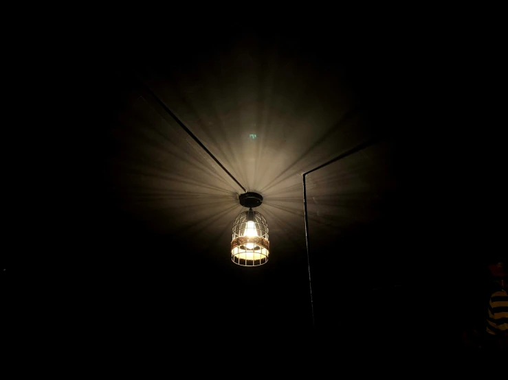 a light bulb is illuminated on a dark street