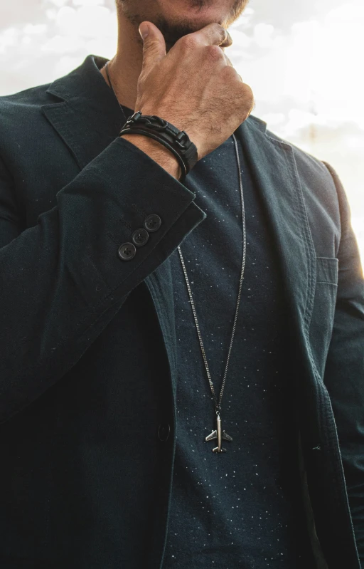 man standing with his hand on his neck in a tie