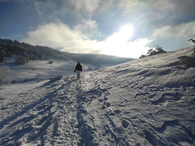 a skier skiing up the side of a snowy mountain