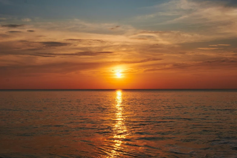 the sunset or sunrise or sunset can be seen in the water