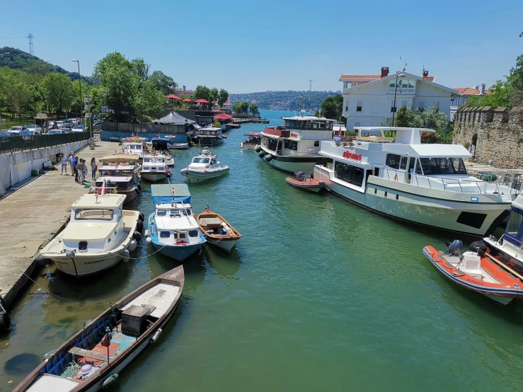 many boats docked at the pier in a small town