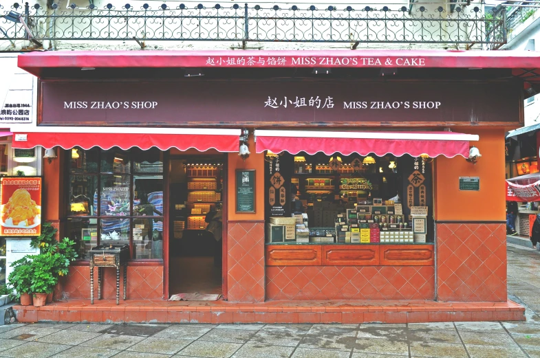 a restaurant on the street with colorful awnings and flower pots