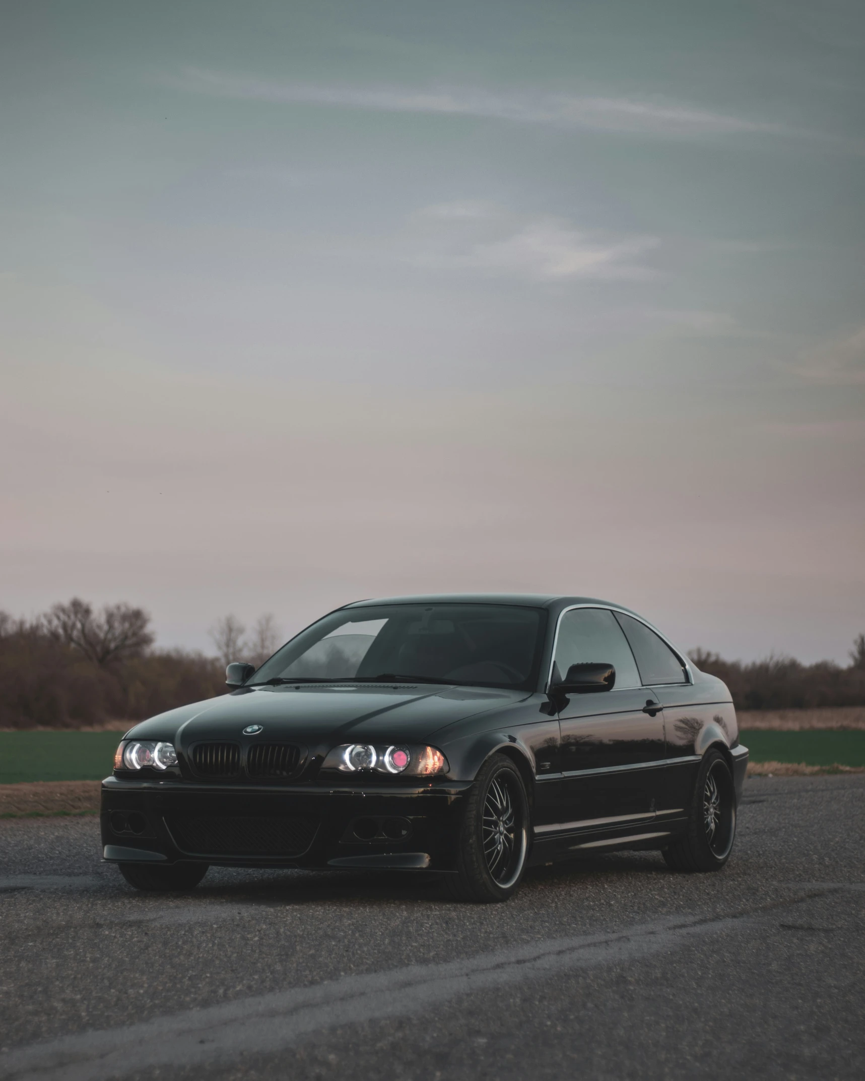 a black car that is driving down the road