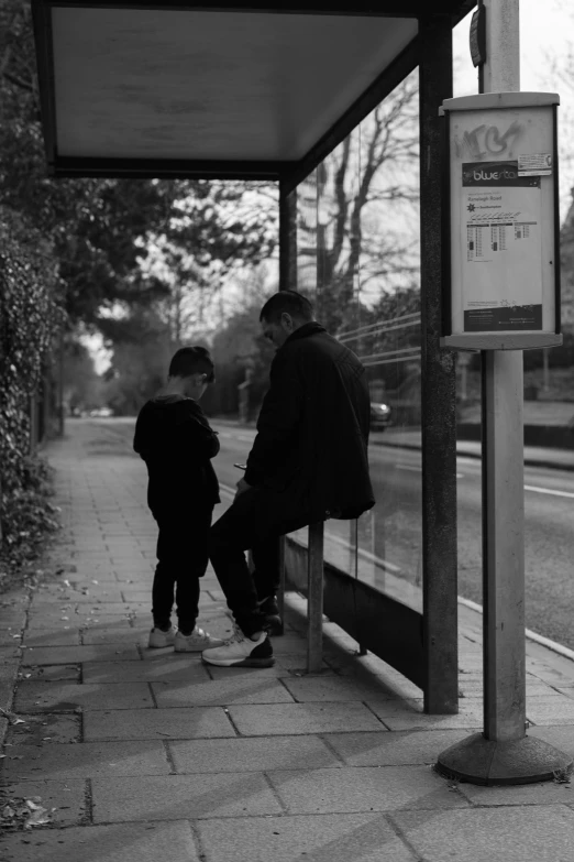 a couple of people that are standing on a sidewalk