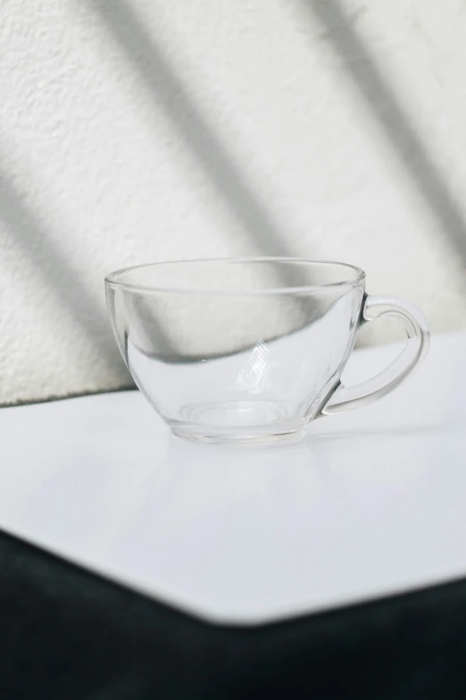 a cup with white water on it sitting on a white surface
