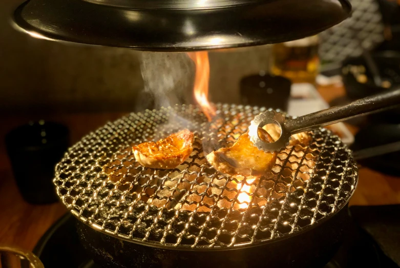 the smoke comes out from an outdoor grill