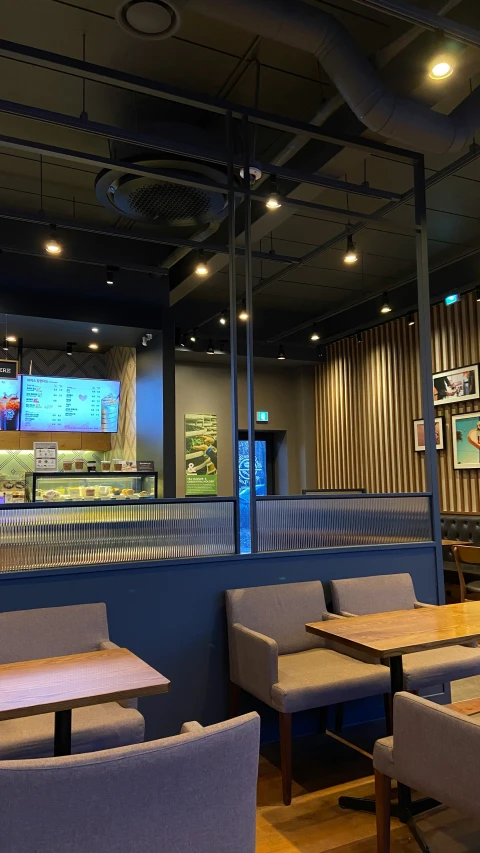 a sports stadium has a television and a long dining area