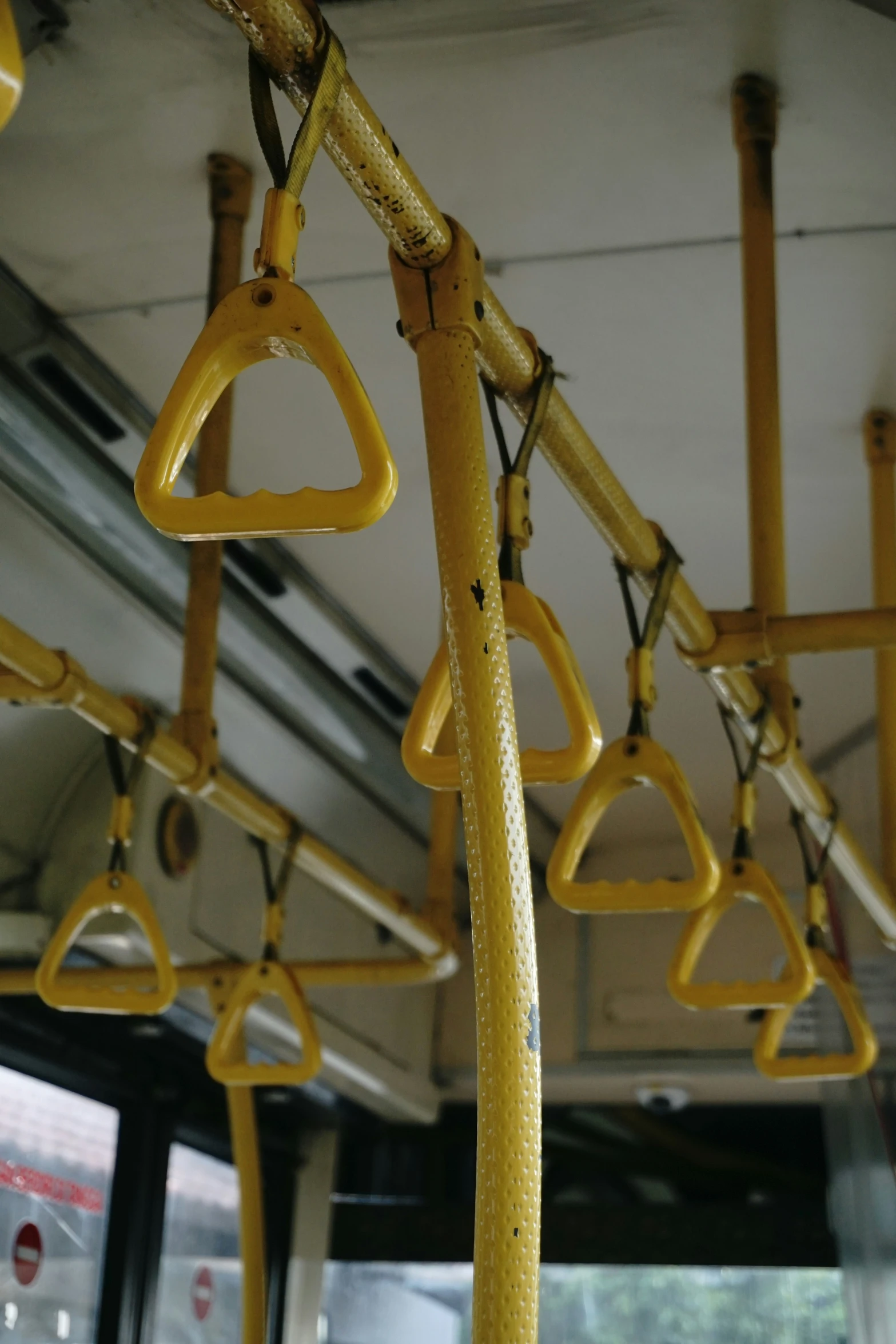 the interior of a public transit vehicle with bars and hooks