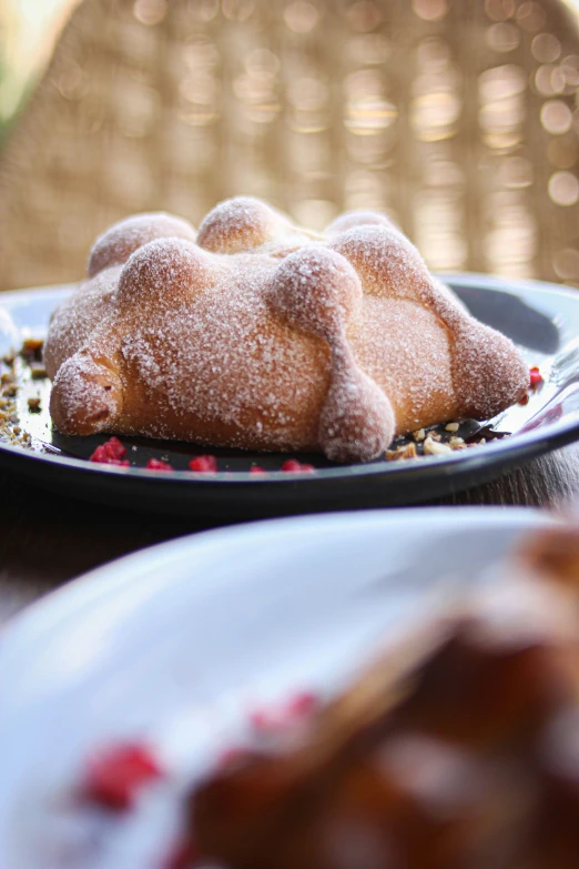 two desserts sitting on top of a black plate